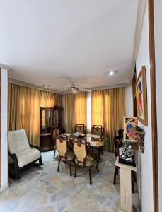 a living room with a table and chairs at Villa Ceci - Piscina Privada 24 horas in Girardot +5 photos