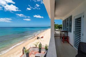 a balcony with a view of the beach at Coconut Palms Inn in Rincon