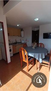 a kitchen and dining room with a table and chairs at Excelente Departamento en Calle 44 - Deptos Apolo in Las Toninas +15 photos