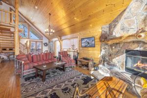 ein Wohnzimmer mit Kamin in einer Blockhütte in der Unterkunft Pegasus Luxe Mnt Retreat Stunning Views & Hot Tub in Big Bear Lake