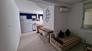 a living room with a couch and a kitchen at Lovely 1-Bed Apartment in lac1 Tunis in Tunis +12 photos