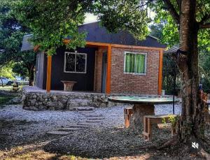 a small house with a table in front of it at Punto Campestre in Cueva de los Pajaritos