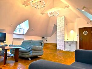 a living room with a couch and a table at EXCL HOUSE in Warsaw with POOLS in Józefów