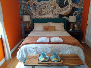 a bedroom with a bed with a tray of food on it at The Lemon Zest Cottage Paws Welcome in Pensacola +88 photos