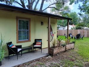 a screened in porch of a house with chairs at Winter Escape Pet Friendly Cottage with Jacuzzi Tub and Reading Nook in Pensacola