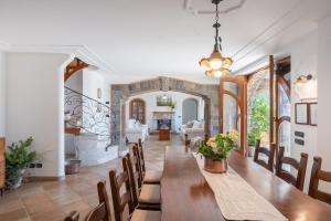 a dining room with a long table and chairs at Villa Esposito in Massa Lubrense