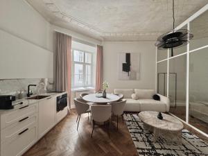a kitchen and living room with a table and a couch at La Belle Epoque in Warsaw +264 photos