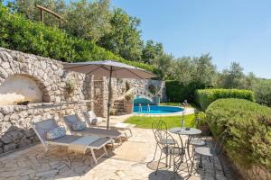 a patio with an umbrella and chairs and a pool at Villa Esposito in Massa Lubrense +53 photos