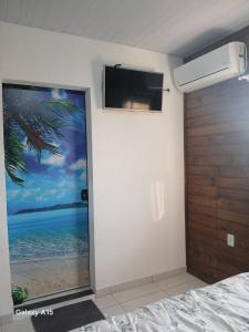 a bedroom with a door with a view of the ocean at Vilamar in Florianópolis
