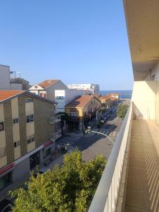 a view of a city street from a balcony at Apartamento T2 Vista mar in Vila do Conde