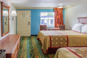a hotel room with two beds and a window at Days Inn by Wyndham Virginia Beach Town Center in Virginia Beach +10 photos