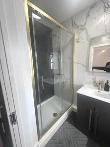 a bathroom with a glass shower and a sink at 2 Bedroom Flat in Marlborough House Cardiff Centre in Cardiff