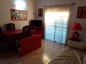 a living room with a dining room table and a window at Cabañas Mi Capricho in Santa Rosa de Calamuchita