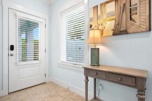 a room with a table with a lamp and a window at Heated Pool Elevator Game Room & Ocean Decks in Coquina Gables +85 photos