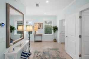 a bathroom with a sink and a mirror at Heated Pool Elevator Game Room & Ocean Decks in Coquina Gables