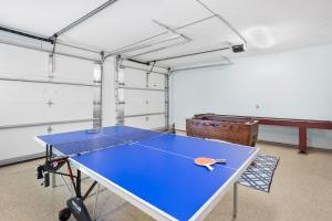 a ping pong table in a room with at Heated Pool Elevator Game Room & Ocean Decks in Coquina Gables