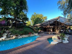 a resort with a swimming pool and a pavilion at Fazenda Boutique Vila dos Eucaliptos in Atibaia