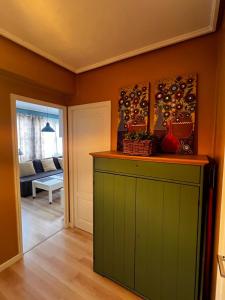 a kitchen with a green cabinet in a room at Vivienda Sol in Ferrol