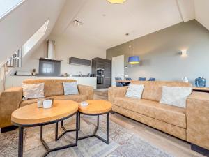 a living room with a couch and a table at Top luxe 27G in Colijnsplaat