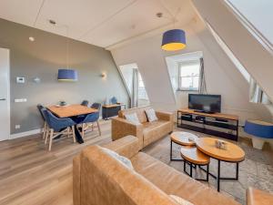 a living room with a couch and a table at Top luxe 27G in Colijnsplaat