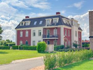 a large red and white house on the side of a street at Top luxe 27G in Colijnsplaat