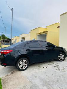 a black car parked in a parking lot at Casa para a COP 30 in Castanhal +3 photos