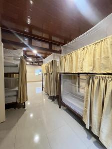 a row of bunk beds in a room at Hostel Mar y Bosque in Drake