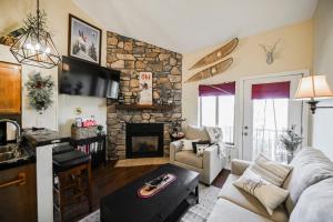 a living room with a stone fireplace at The Hidden Moose in Brian Head
