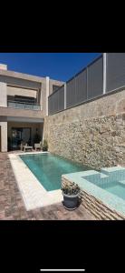 a house with a swimming pool in front of a building at Villa - Djerba in Midoun