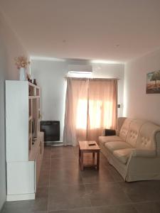 ein Wohnzimmer mit Sofa und Tisch in der Unterkunft Departamento in Trenque Lauquen