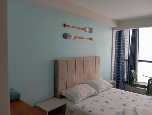 a bedroom with a bed with a wooden headboard and a window at ORA BEACH - Nidinho 1 in Porto De Galinhas +44 photos