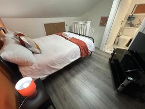 a bedroom with a large bed and a television at Burlington House - Luxury Home for Contractors in West Bromwich +7 photos
