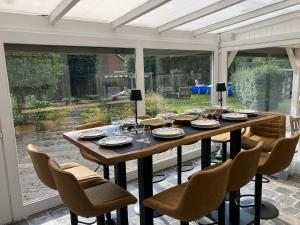 a dining room with a table and chairs at The Oak & Squirrel Villa in Hoogstraten