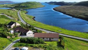 an aerial view of a river with houses and a road at Solheim Self Catering in Whiteness