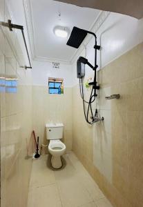 a bathroom with a toilet and a shower at Fancy Homes Bungoma in Bungoma
