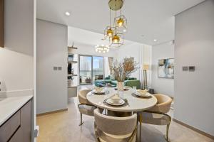 a kitchen and dining room with a table and chairs at Burj Khalifa and Dubai Fountian Direct View - Luxury 2BR Flat - Downtown Dubai in Dubai