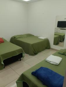 a room with two beds and a mirror at Casa blanca in Belém
