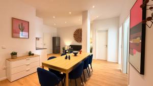 a kitchen and dining room with a table and chairs at BeckHomes Munich - Stylish Central Apartments in Munich +69 photos