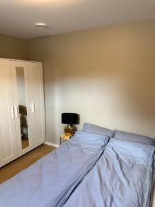 a bedroom with a bed and a wall at New and bright studio near Kristiansand Zoo and Kjevik airport in Kristiansand +5 photos