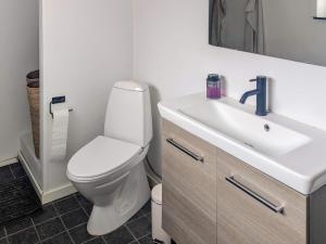 a bathroom with a white toilet and a sink at 6 person holiday home in Gram in Gram +19 photos