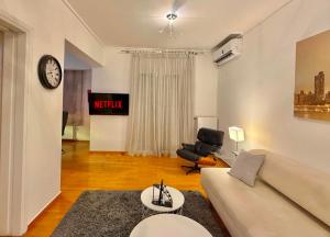 a living room with a couch and a chair at Central Glyfada 2BR Apartment in Athens