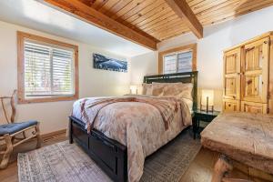 a bedroom with a bed and a wooden ceiling at Retreat with Private Hot Tub steps North Lake Tahoe in Carnelian Bay