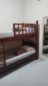 two bunk beds in a room with a mirror at Vivenda Paz do Jubim in Salvaterra