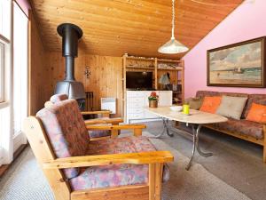 a living room with a couch and a stove at Tranquil Haven near Beach - By Traum Ferienwohnungen in Rødby