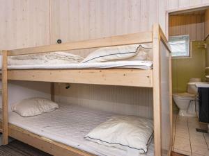 a couple of bunk beds in a room at 4 person holiday home in Rønde-By Traum in Rønde