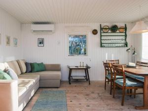 a living room with a couch and a table at 4 person holiday home in Knebel in Knebel