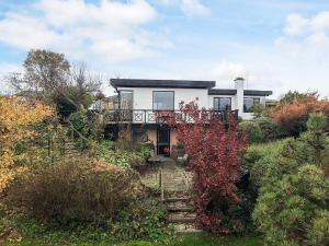 a house on top of a hill with bushes at 5 person holiday home in Hesselager-By Traum in Hesselager