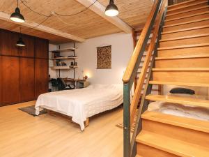 a bedroom with a bed and stairs in a room at 5 person holiday home in Hesselager-By Traum in Hesselager