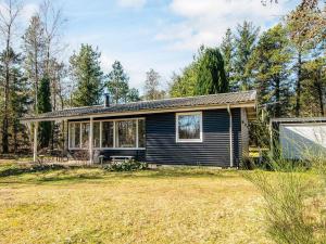 a small black house with a yard at 5 person holiday home in Højslev-By Traum in Højslev