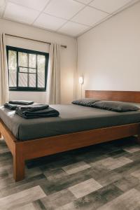 a bedroom with a large bed in a room at PaiPaiHostel in Pai